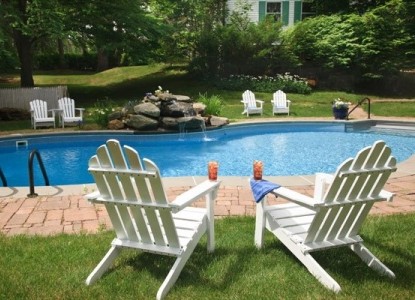 chairs on patio next to pool